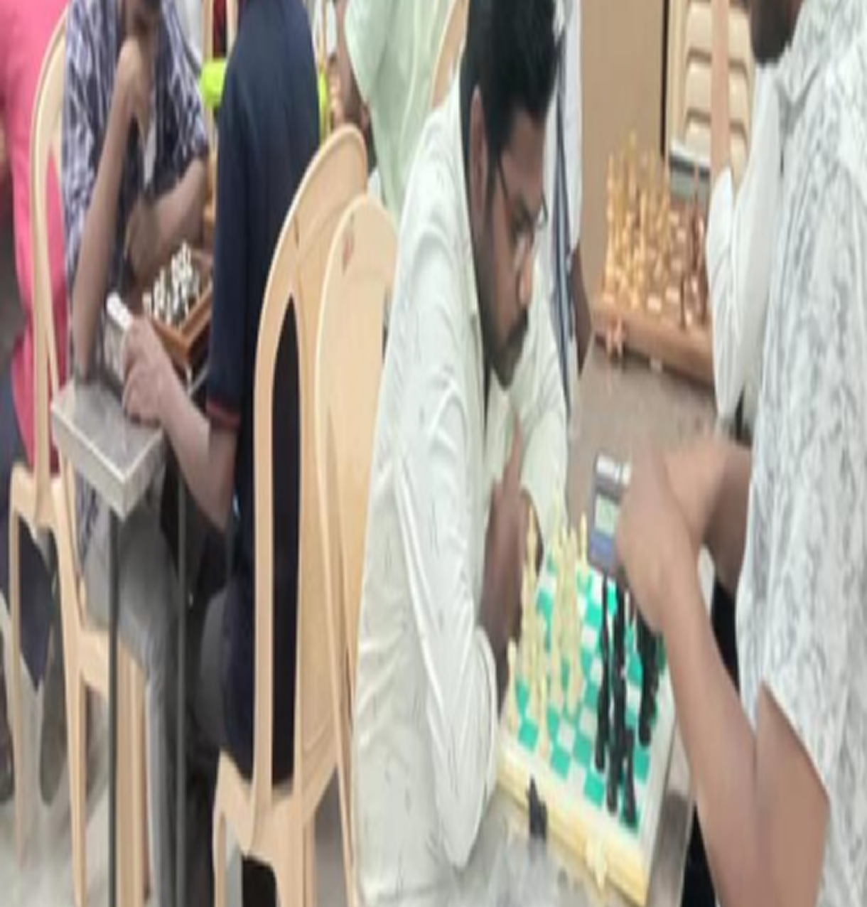 Blind child clapping hands in rhythm beside another playing drum