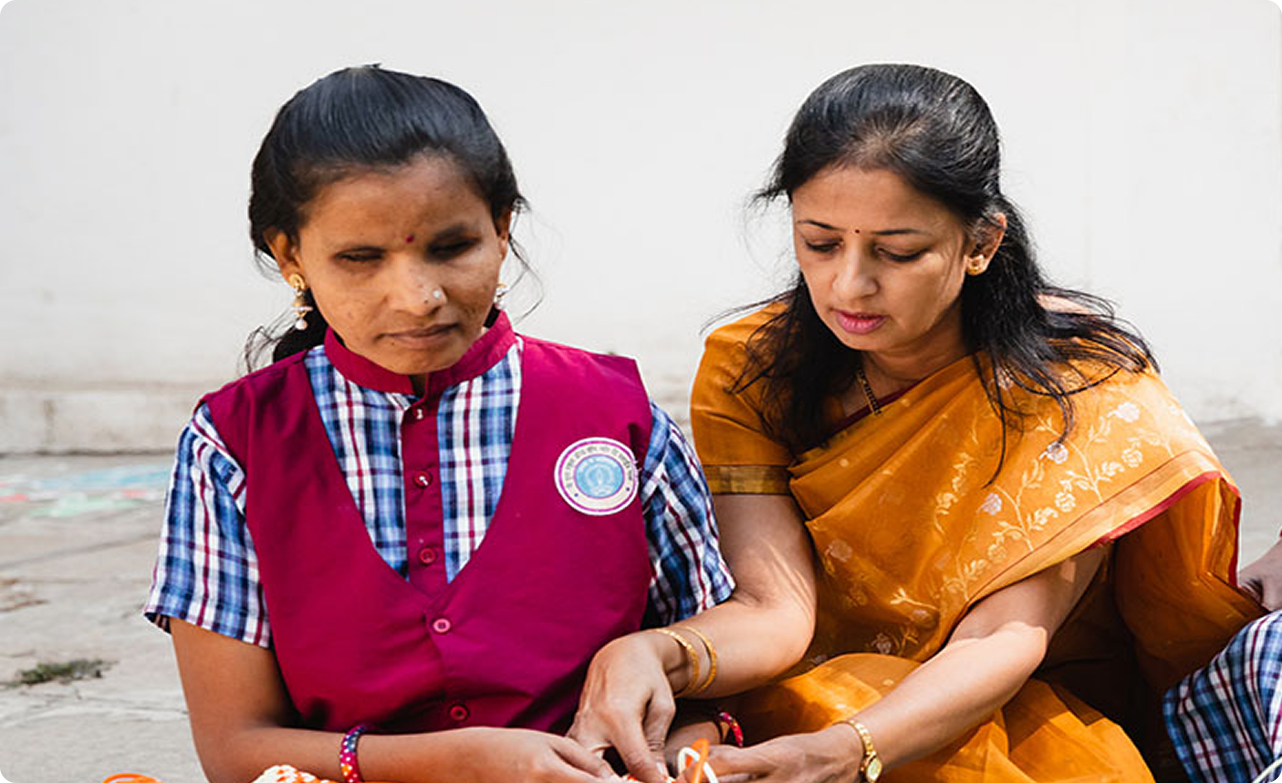 Volunteer guiding a blind student